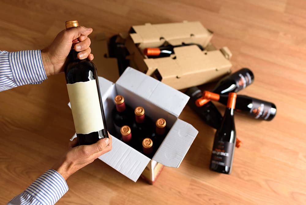 Man opening wine club shipment